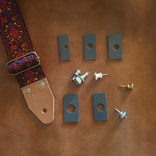 Close-up of guitar strap leather end and various leather pieces  with hole sizes (e.g., 6mm, 8mm standard, 10mm for different strap locks