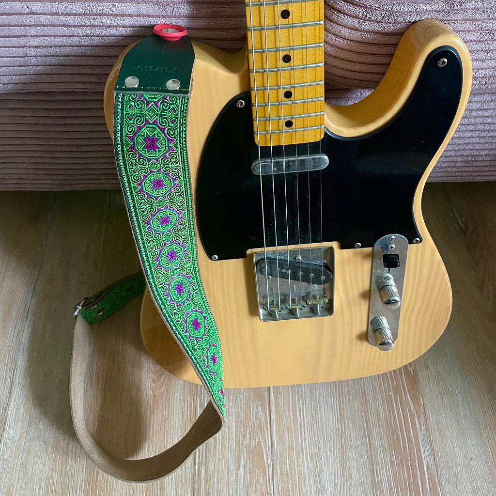 Green guitar strap with purple flowers