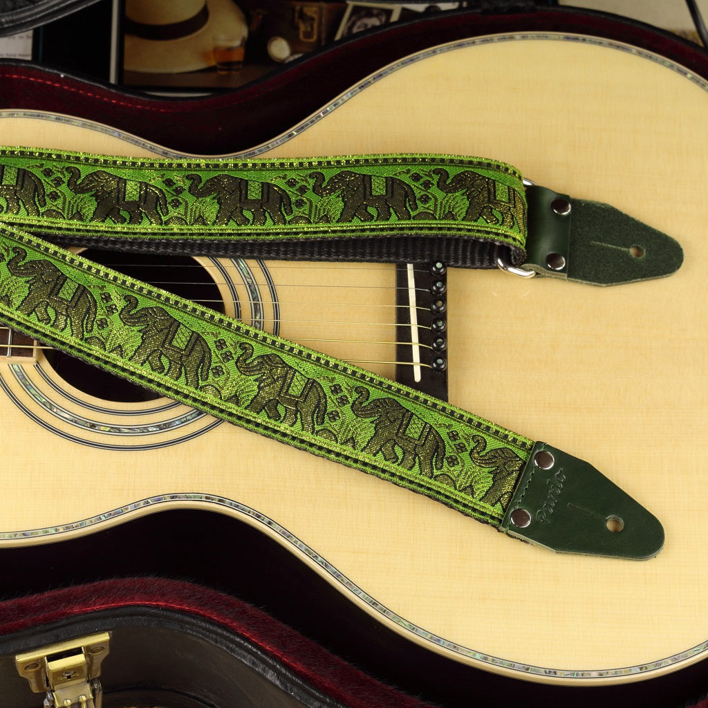 Acoustic guitar boho strap with a green pattern with elephants - paired with an acoustic parlor guitar