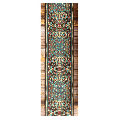 Close-up of the Blue Garden guitar strap design featuring intricate turquoise, ivory and pink details arranged against a dark background.