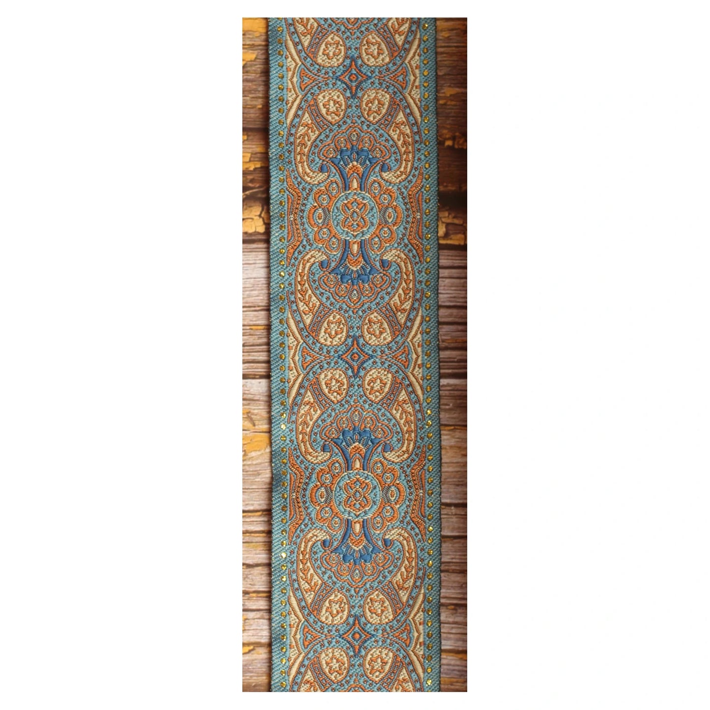 Close-up of the Blusie guitar strap design with symmetrical blue, copper and ivory ornamental details.