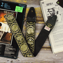 Rear view of the Medal black and gold guitar strap with black seatbelt backing, shimmering jacquard weave and genuine leather ends.