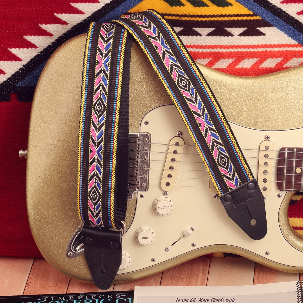 The Black Cherokee Indigenous Style Strap mounted on an FEnder Stratocaster electric guitar, viewed from the side