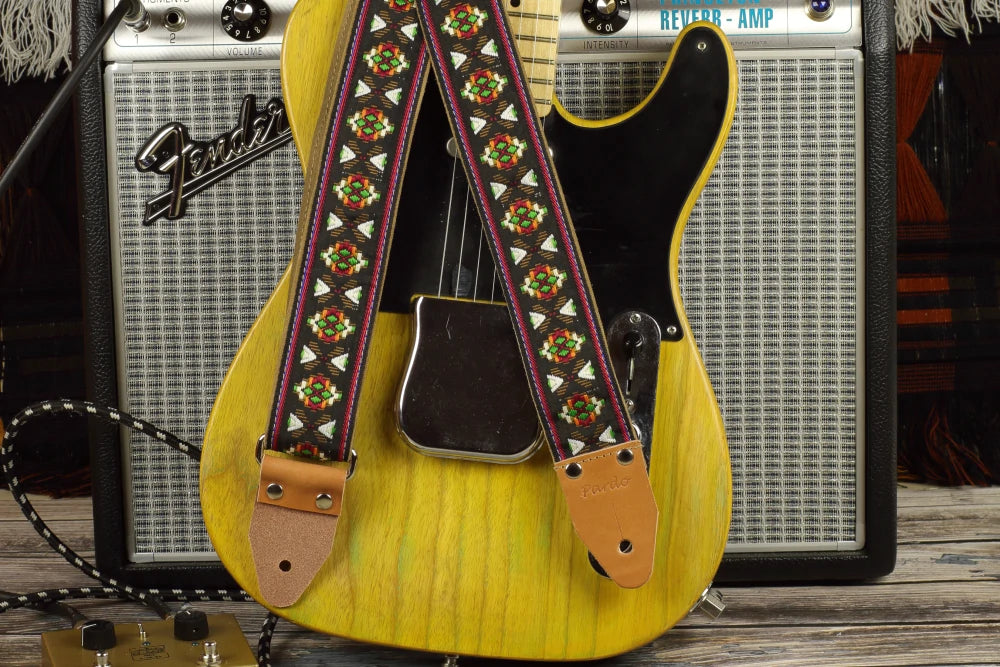 tribal guitar strap made with a woven jacquard fabric with black background and colored geometric shapes