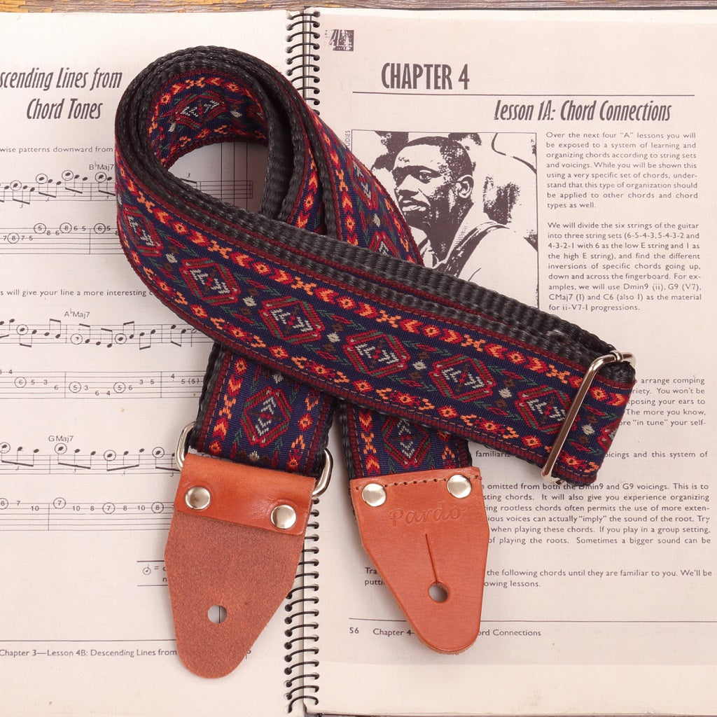 Front view of the Blue Cree guitar and bass strap made from woven jacquard fabric and leather ends parts