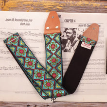 Guitar strap made with a woven jacquard fabric with color blue and small red flowers