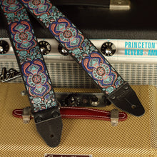 Close-up of the Blue Mirage handmade guitar strap showing genuine leather ends with Fender Princeton Reverb and Fender Champ amplifiers