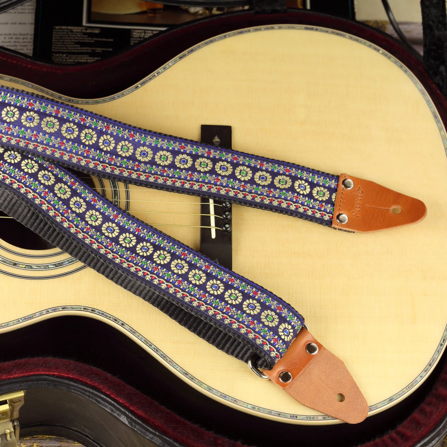 Guitar strap model blue reverie, paired with a parlor acoustic guitar