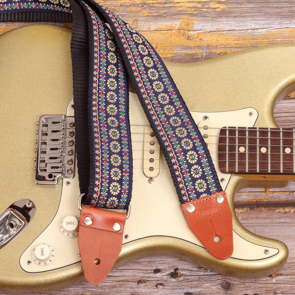 Close-up of Blue Reverie floral guitar strap on Fender Stratocaster Gold Sparkle electric guitar