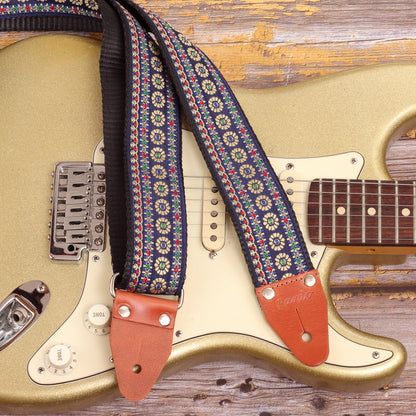 Close-up of Blue Reverie floral guitar strap on Fender Stratocaster Gold Sparkle electric guitar