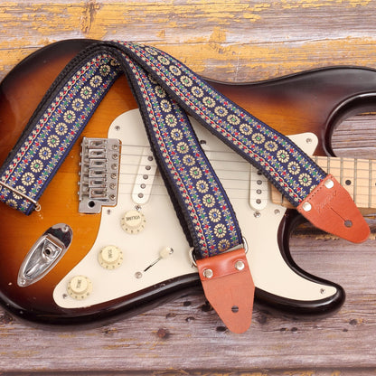 Blue Reverie floral jacquard guitar strap paired with a Fender Stratocaster Sunburst electric guitar 