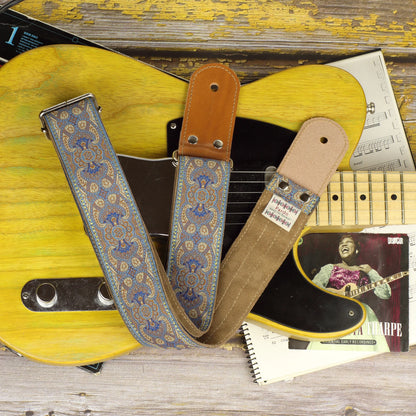 Blusie guitar strap displayed on a Fender Telecaster ’52, showing its round leather end and Clear Brown suede backing.
