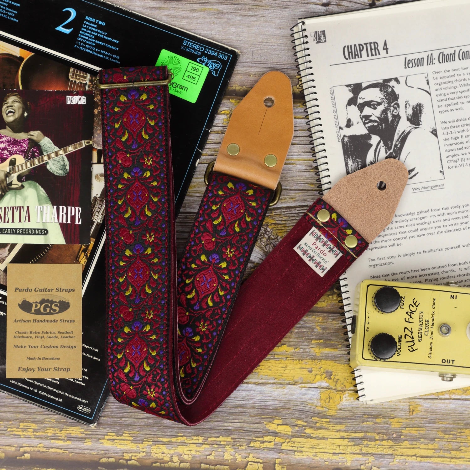 Burgundy Pheasant guitar strap showing its jacquard pattern, red burgundy suede backing and light brown leather ends