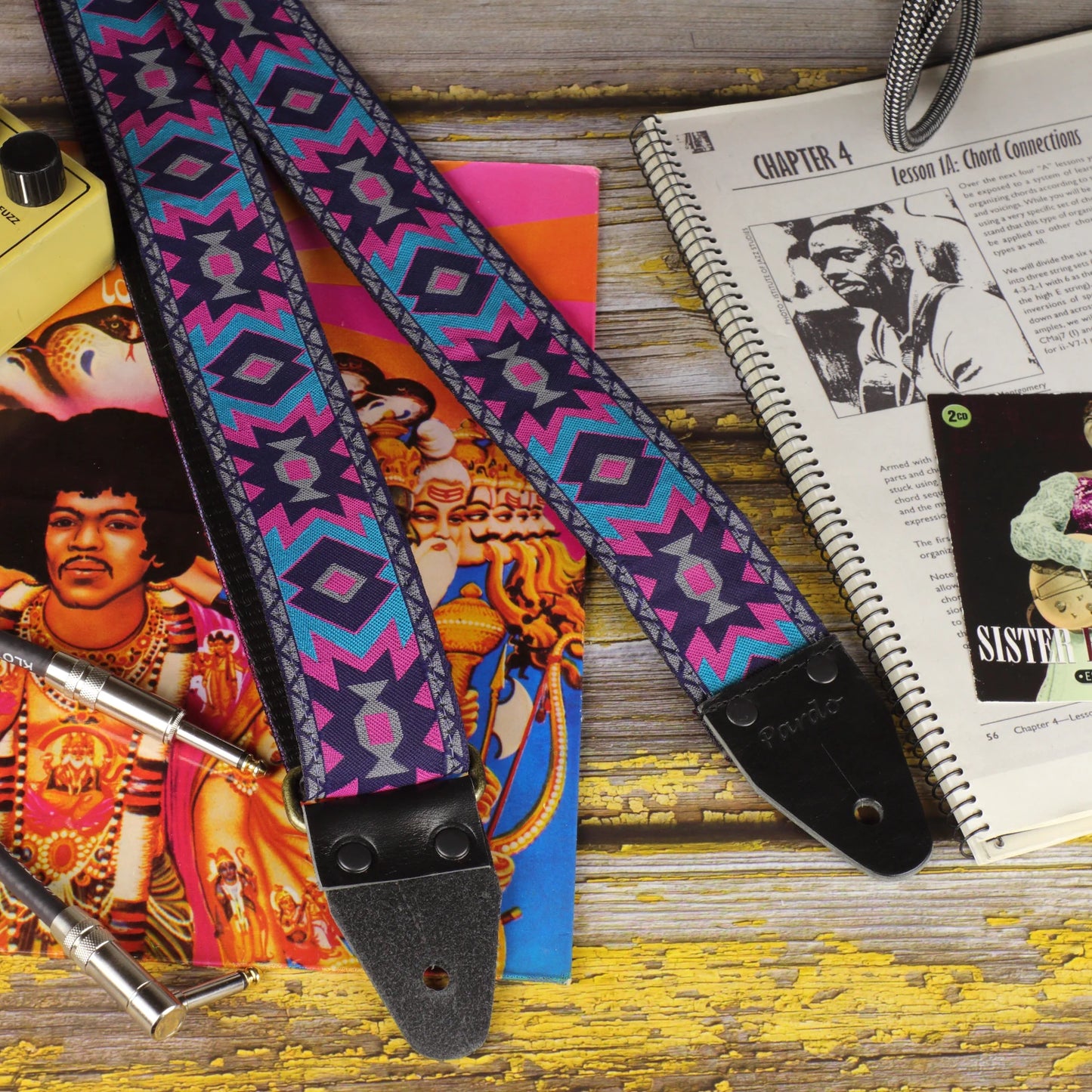 Close-up of the Canyon Pulse guitar strap showing its geometric jacquard pattern and black leather ends.
