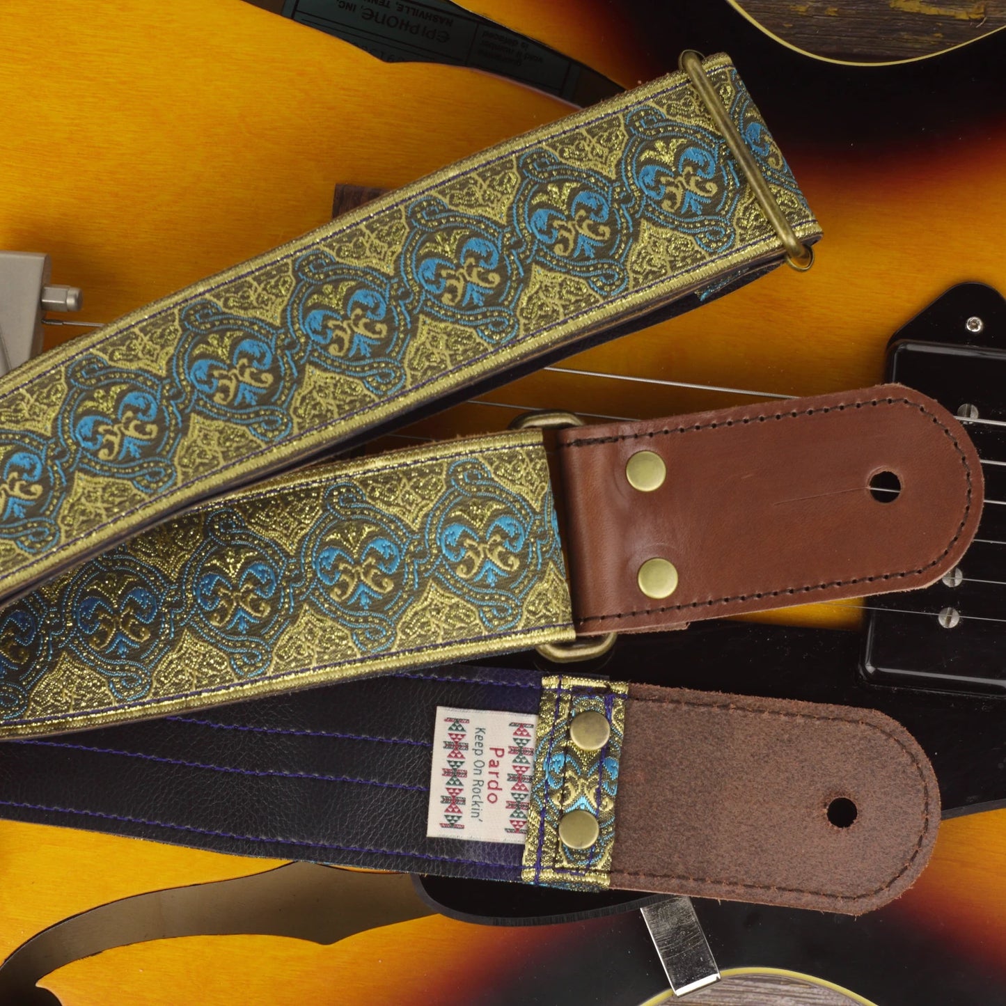 Close-up of the Dune guitar strap showing its jacquard pattern, dark brown round leather ends and Dark Blue Vinyl backing.
