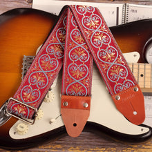 Strap attached to an electric stratocaster guitar, highlighting its 2.5-inch width.