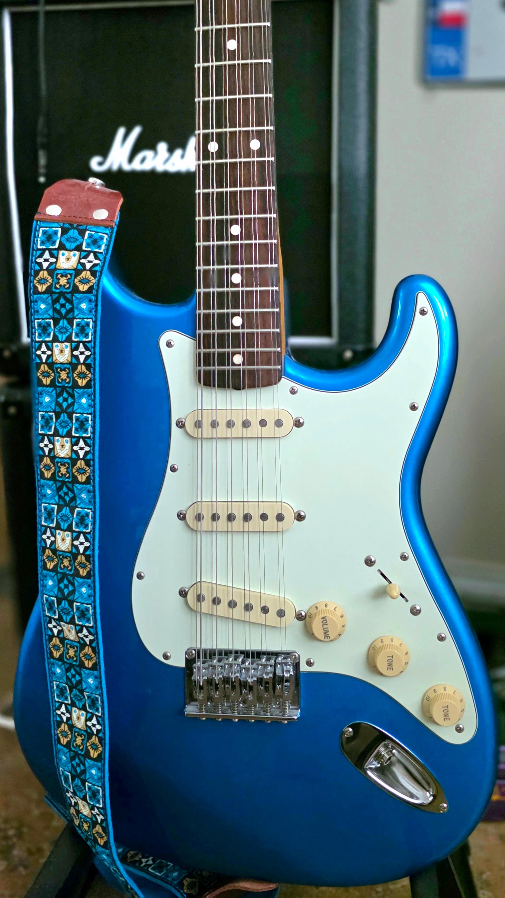 Made-in-Japan Fender XII 12-string guitar in sparkling Lake Placid Metallic Blue, paired with a Blue Woodstock guitar strap.