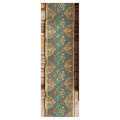 Close-up of the Dune guitar strap design with repeating turquoise loops, bronze tones and finely detailed golden lines.