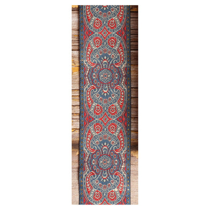 Close-up of the Efrit guitar strap design featuring symmetrical red, ivory and slate blue medallions and ornamental details.