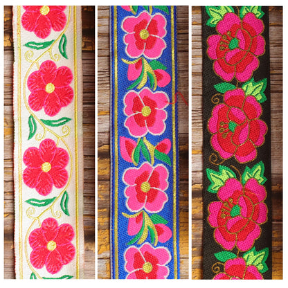 Three Grand Petal guitar strap designs shown together: Ivory Garland, Blue Serenade and Midnight Cameo.