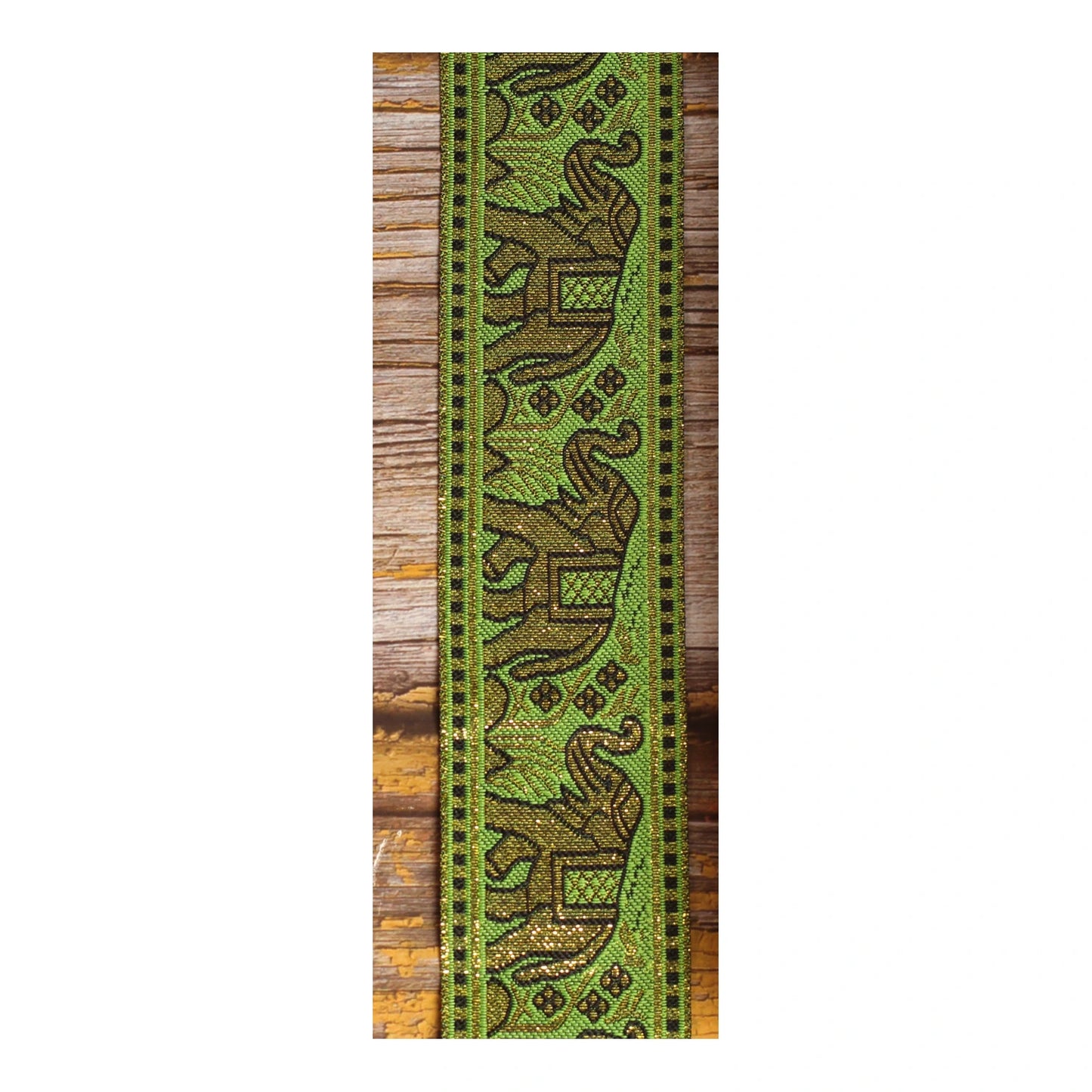Green and gold woven guitar strap with repeating elephant jacquard motifs and ornamental details
