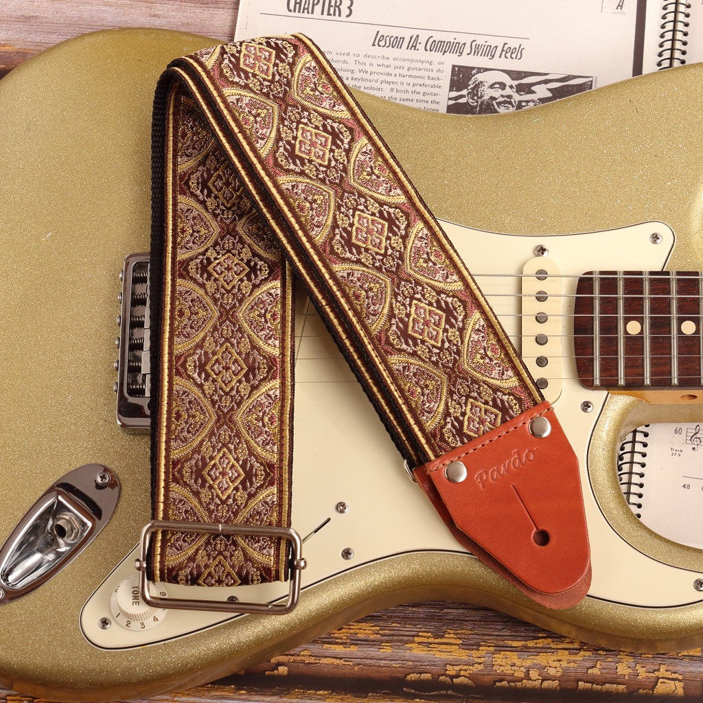 wide Brown Mountain Guitar strap model attached to a Fender stratocaster color Gold Sparkle