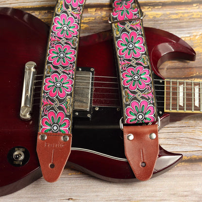 Flowers of Springs handmade jacquard guitar strap with pink floral pattern displayed on a vintage red SG electric guitar.