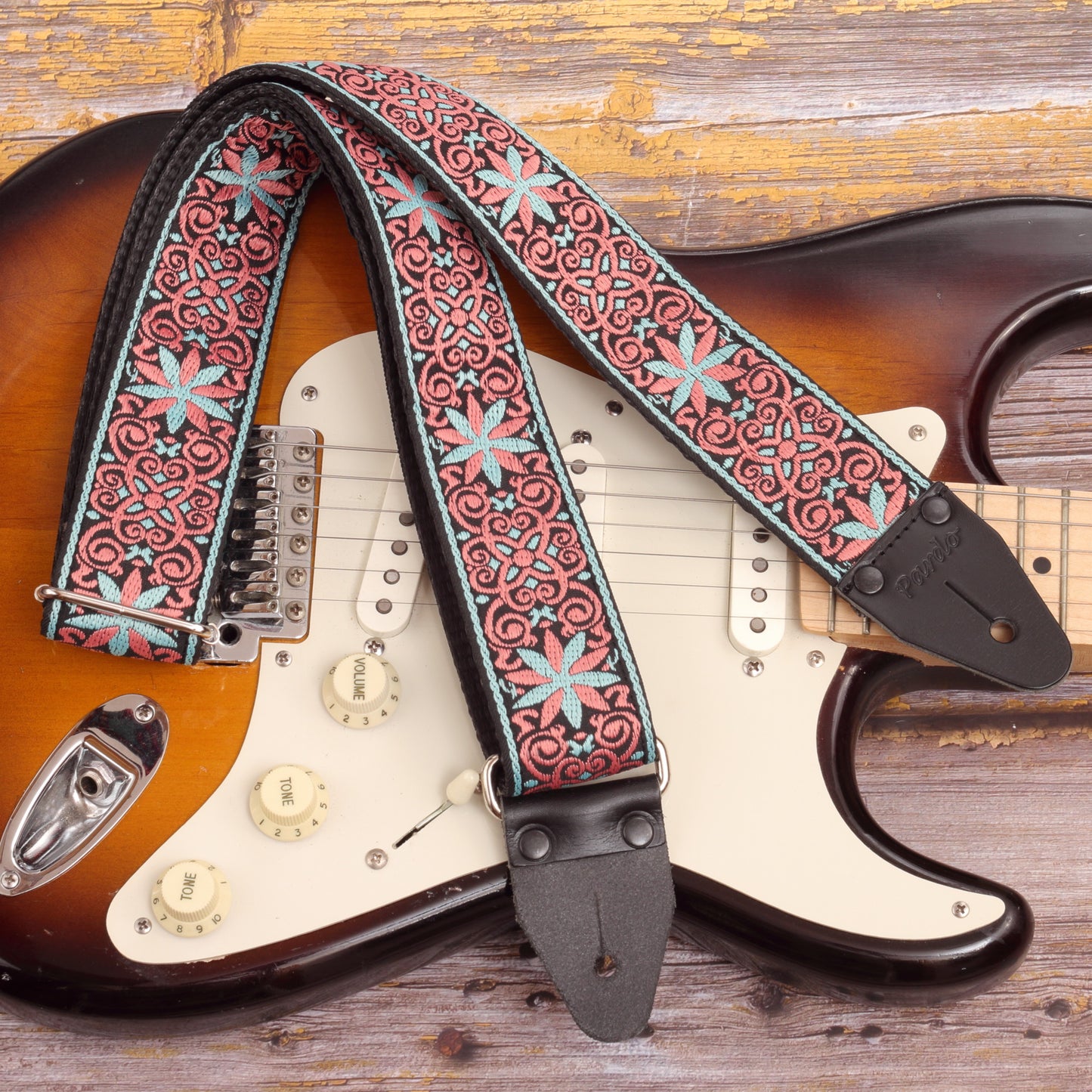hippie guitar strap with stars paired with a fender strato sunburst