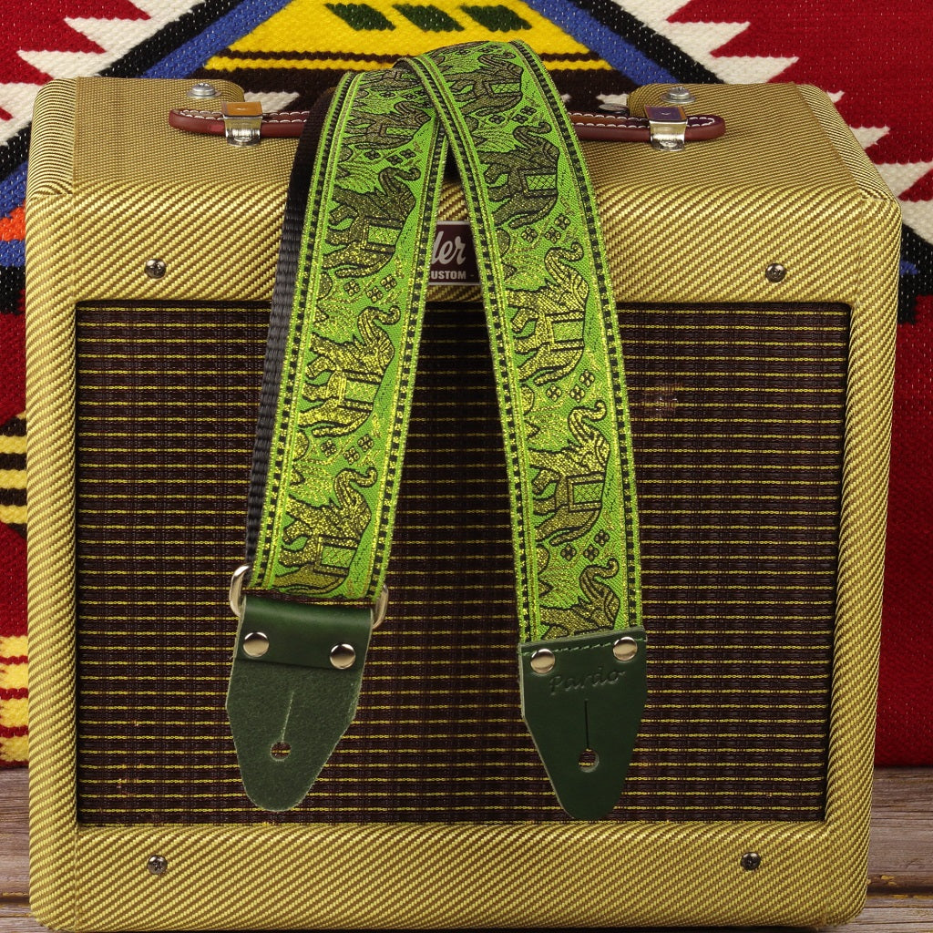 Handcrafted spanish guitar strap with green colors and elephants pattern, paired with a Fender Champ amplifier