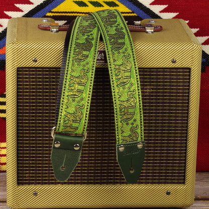 Handcrafted spanish guitar strap with green colors and elephants pattern, paired with a Fender Champ amplifier