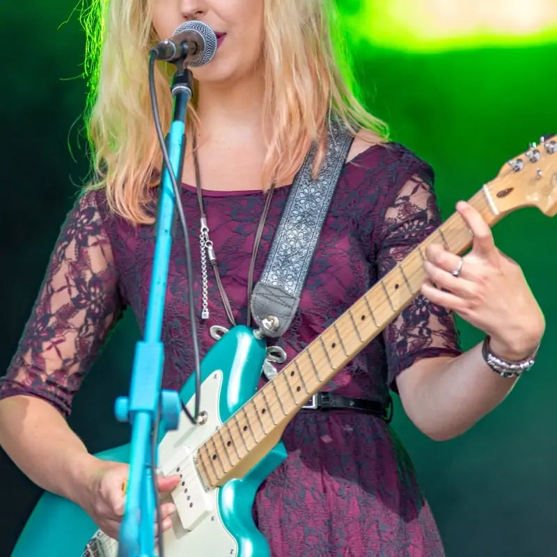 Hippie style girl playing electric guitar