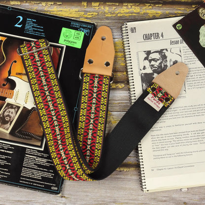 Hootenanny guitar strap bohemian style inspired in 60s hippie patterns, frontview showing the leather ends parts, metal hardware and backing seatbelt color black