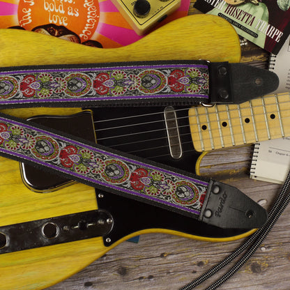 Close-up of the King guitar strap displayed on a Fender Telecaster ’52, showing its red, purple, green and ivory design.