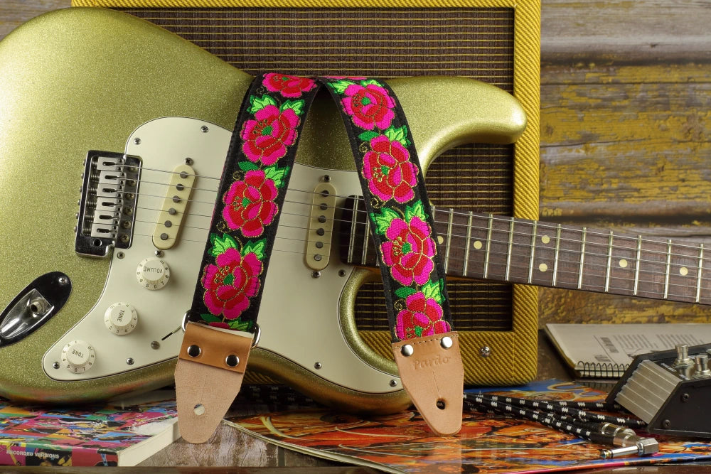 Midnight Cameo guitar strap displayed with a gold sparkle Fender Stratocaster and a Fender Pro Junior amplifier.