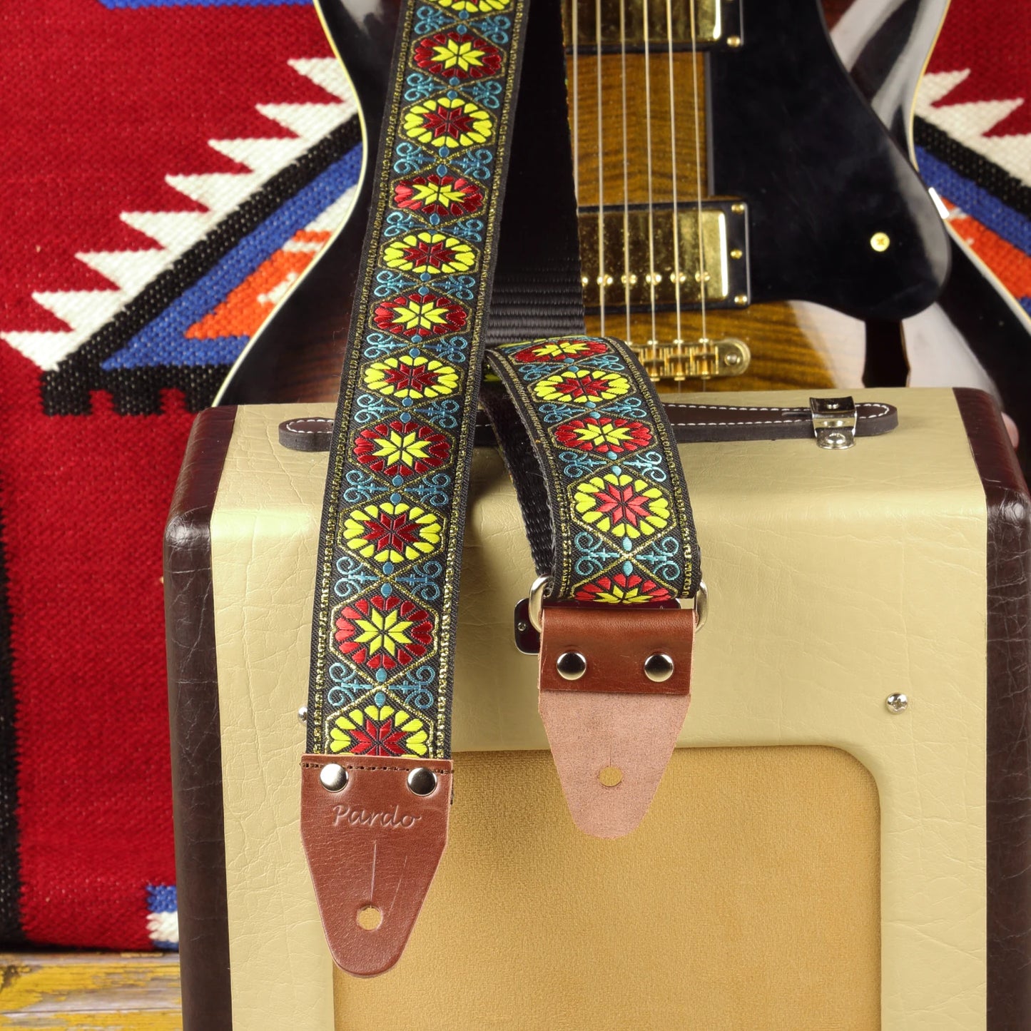 Midnight Carnival woven guitar strap displayed with a semi-hollow electric guitar and Fender Champion 600 amplifier.