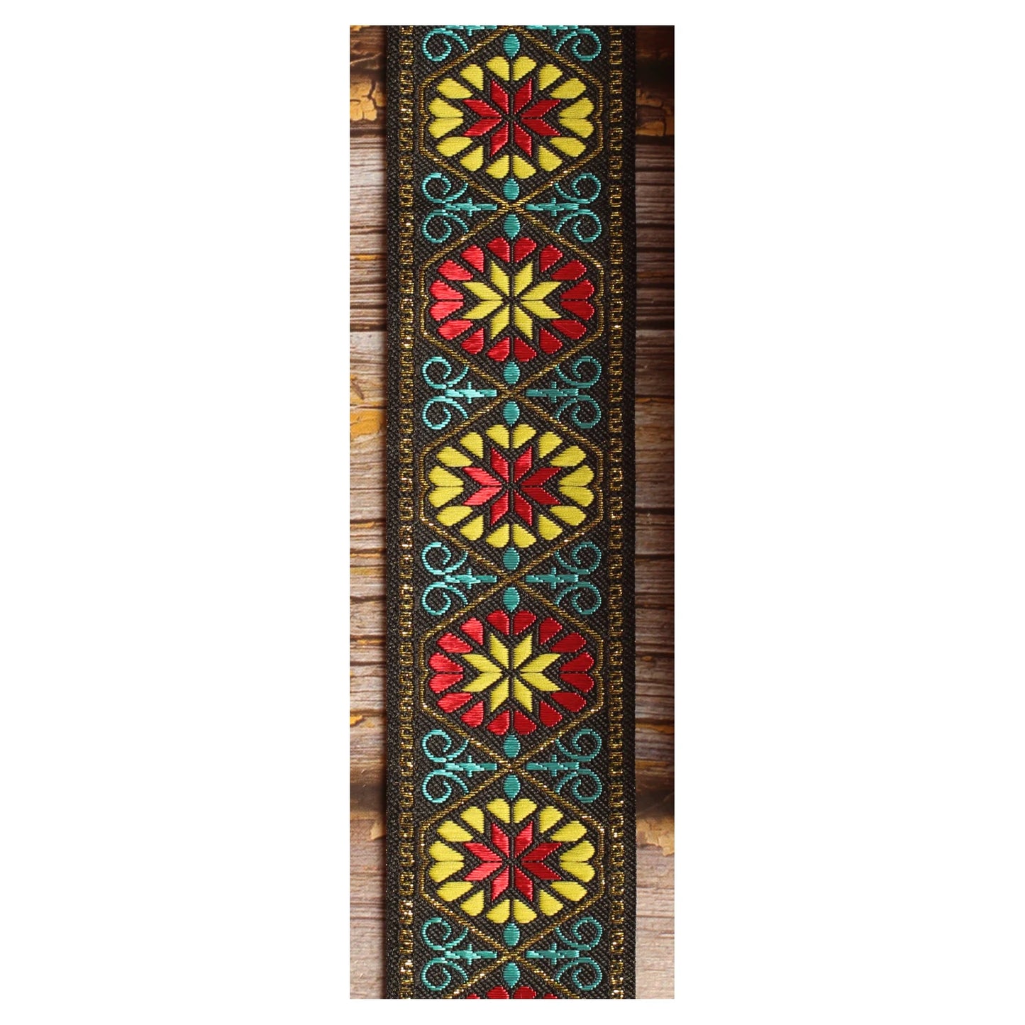 Midnight Carnival woven guitar strap featuring multicolored botanical motifs against a black background.
