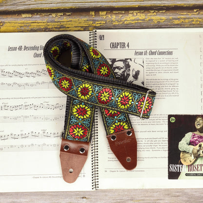 Close-up of the Midnight Carnival strap showing the detailed woven fabric, multicolored motifs and genuine leather ends.