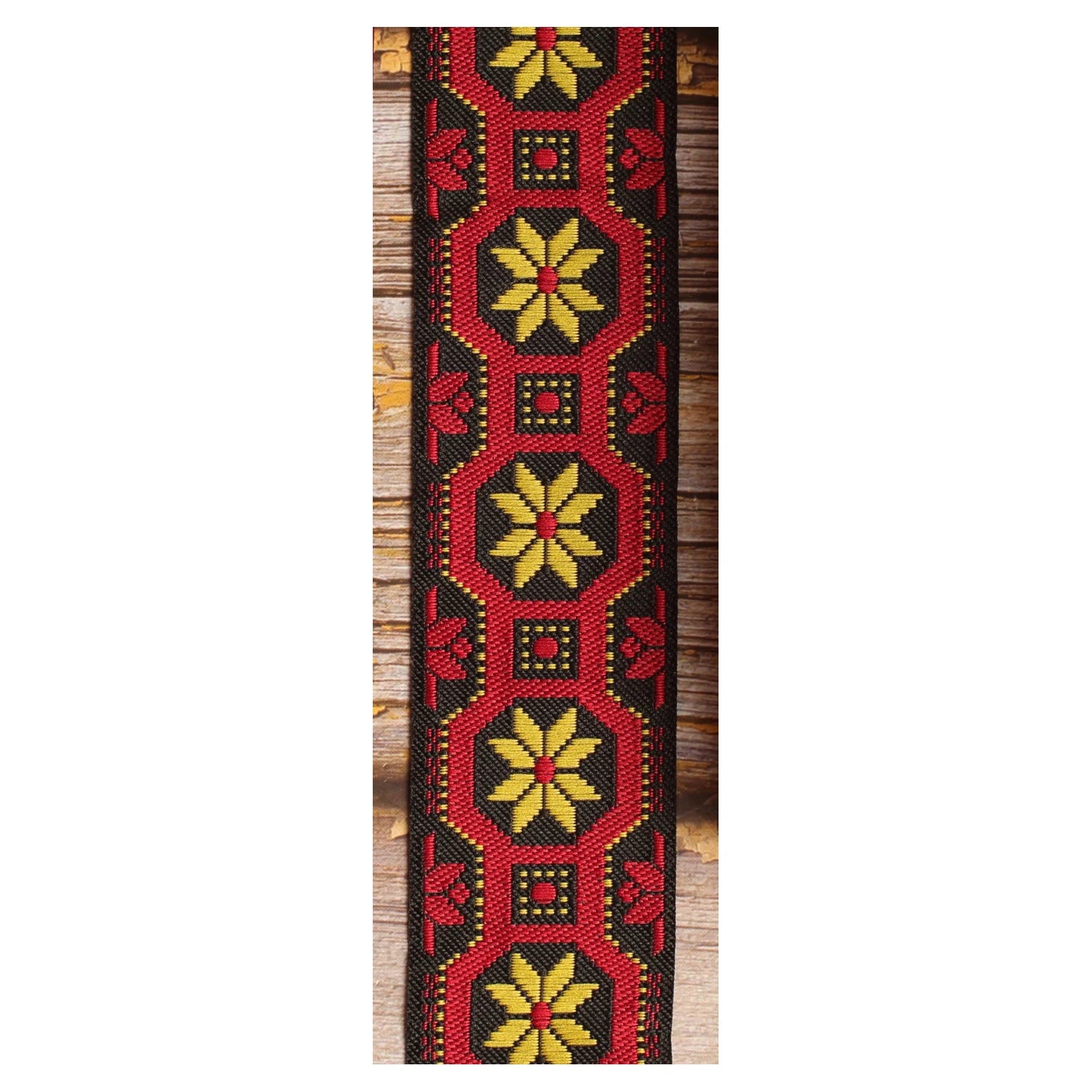 Mod Frame woven guitar strap featuring yellow decorative motifs framed in black with a distinctive 1960s-inspired look.