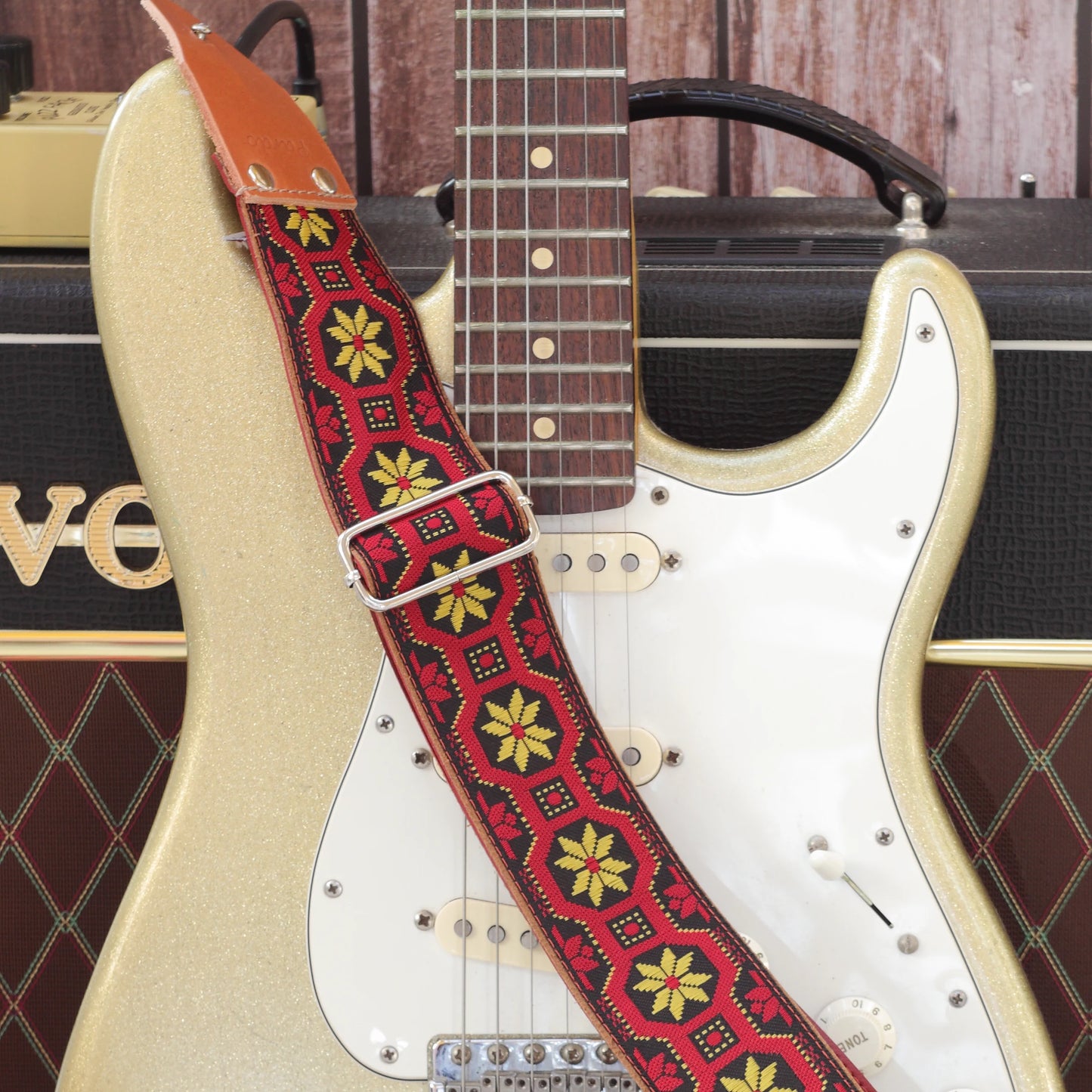 Mod Frame woven guitar strap displayed with a Fender Stratocaster, showing the full strap and its distinctive 1960s-inspired geometric pattern.