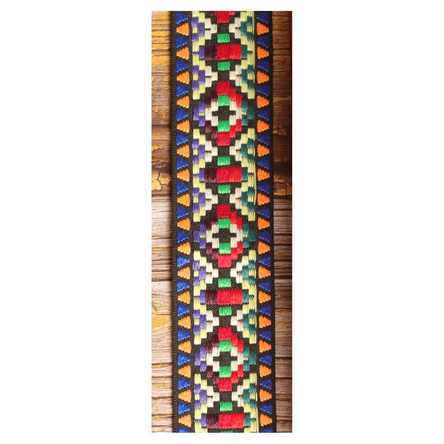 Close-up of the Prism Mosaic guitar strap design with multicolored geometric shapes woven against a dark background.