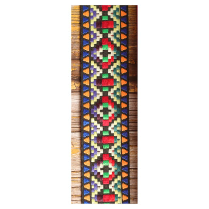 Close-up of the Prism Mosaic guitar strap design with multicolored geometric shapes woven against a dark background.