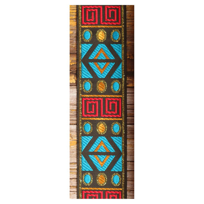 Close-up of the Sunstone Circuit guitar strap design featuring turquoise, red and golden geometric panels on a dark background.