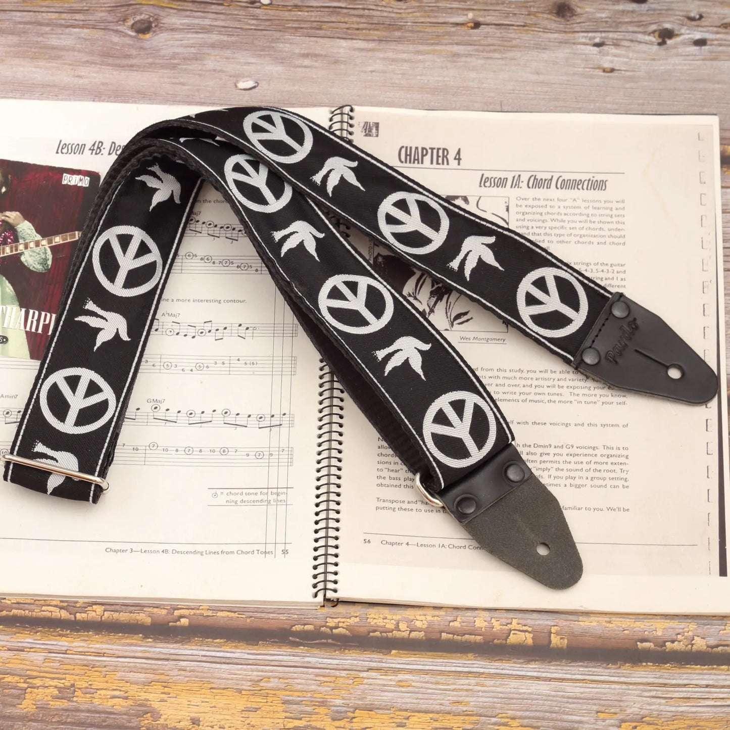 Neil Young Guitar Strap main view with black jacquard fabric and white peace dove design.