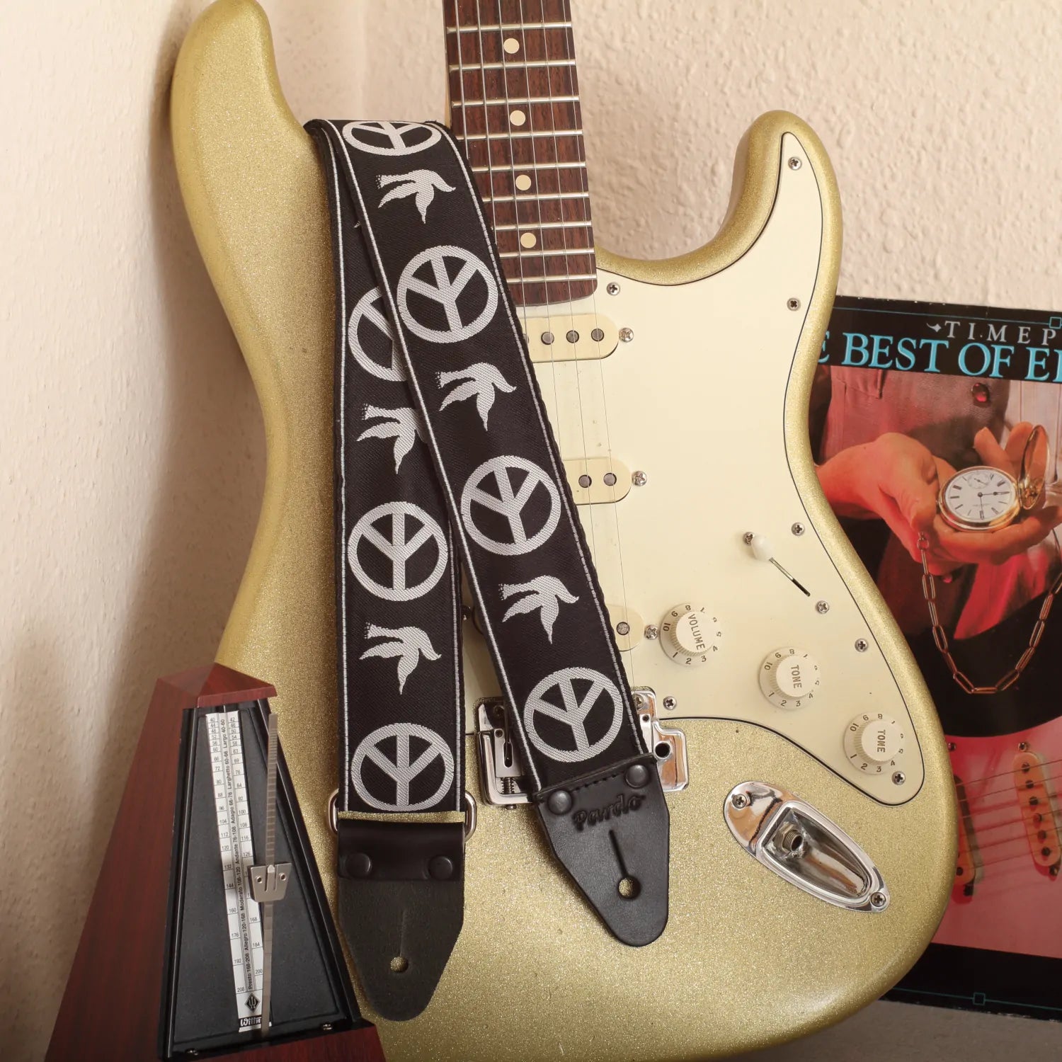 The Neil Young Guitar Strap attached to a classic Gold Sparkle Stratocaster electric guitar.