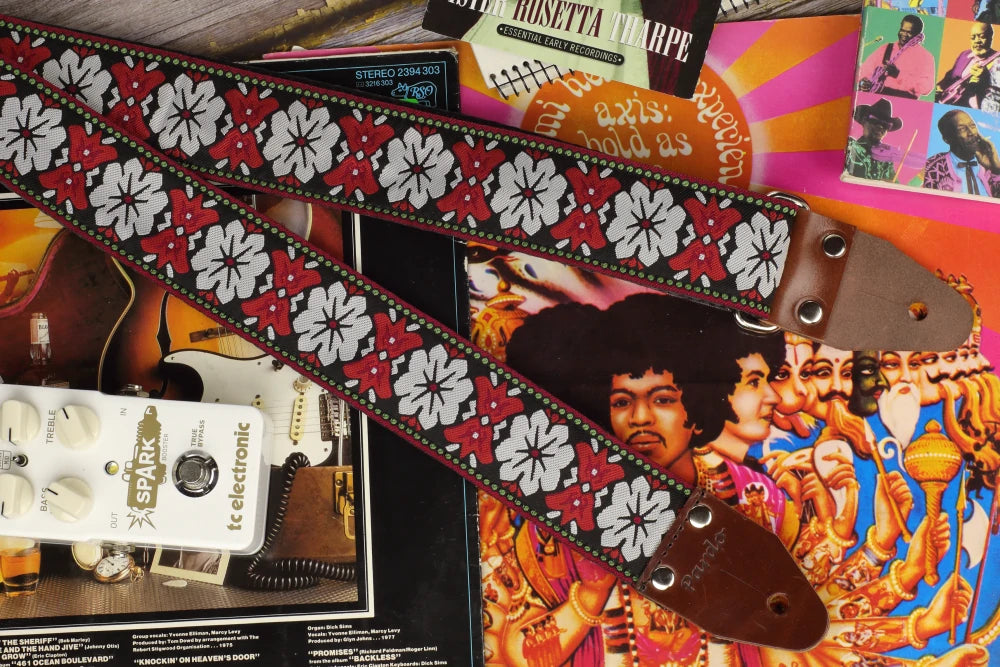 iconic hippie guitar strap with a floral jacquard patterns inspired in 60s style