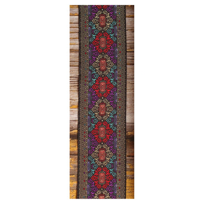 Close-up of the Purple Frame guitar strap design featuring intricate red, purple and turquoise motifs with metallic details on a dark background.