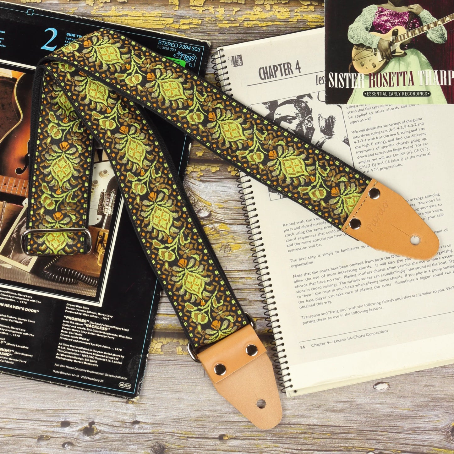 Full view of the Ochre Pheasant guitar strap with its jacquard pattern and light brown leather ends
