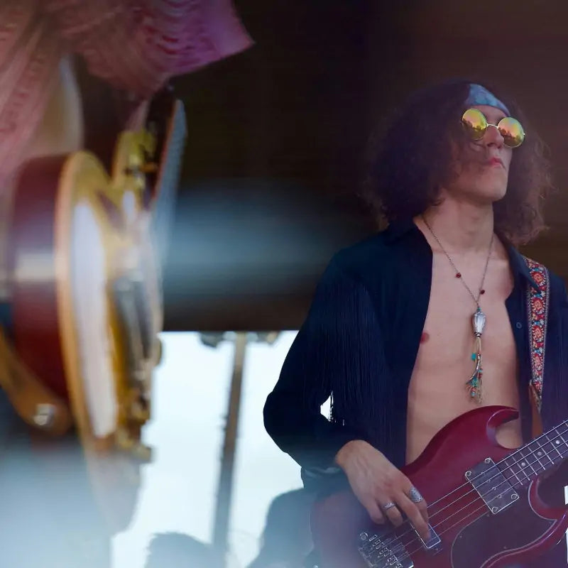 Psychedelic 60s style bassist playing live on stage
