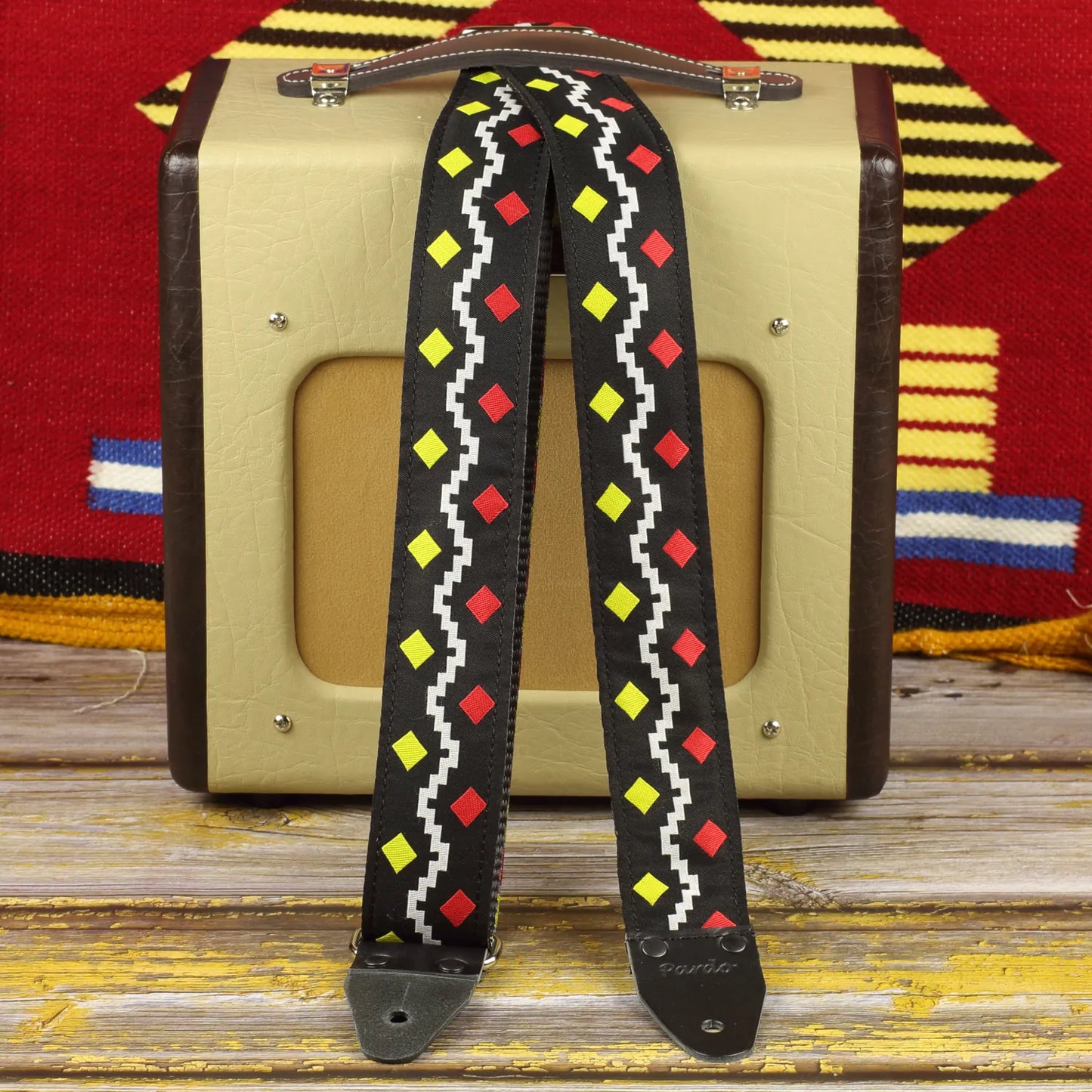 Psychedelic guitar strap inspired by the George Harrison model, shown with a Fender Champion 600 amp