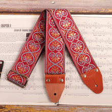 Front view of the red jacquard guitar strap with blue intricate  laces 